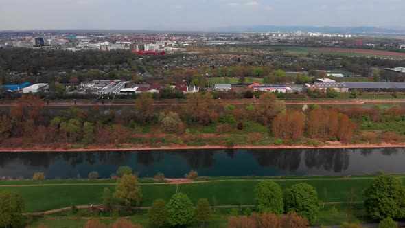 Top view of the embankment of the Neckar River. Bridges, green grass and trees. Mannheim. Germany. alt