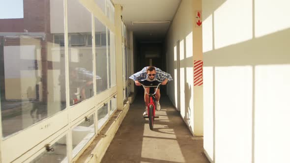 BMX rider in an empty warehouse alt