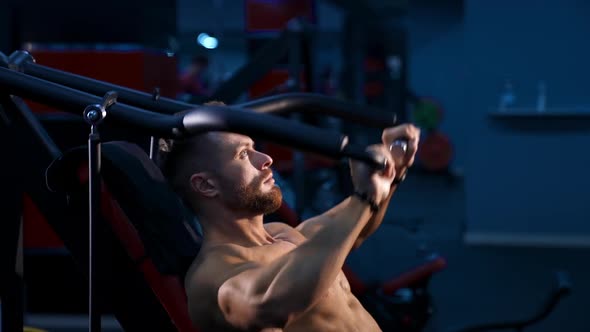 Shirtless young bodybuilder doing workout for chest. Strong abs. Slow motion. alt