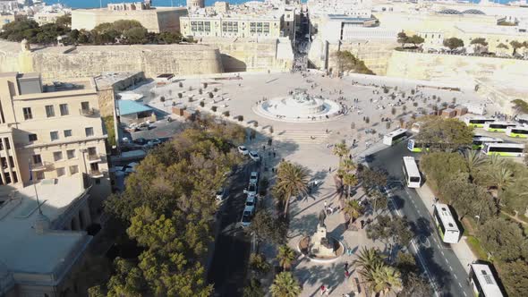 The Triton Fountain outside the City Gate of Valletta, Malta. Aerial forward alt