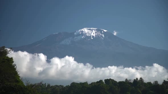 Long Time Lapse of White Clouds Move Below Majestic Kilimanjaro Snowy Mountain