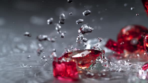 Ruby spinning on water surface. Slow Motion. alt