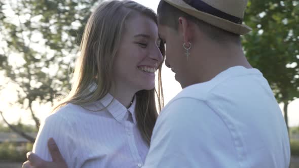 Couple in love and happy kissing in the park. Orbital movement