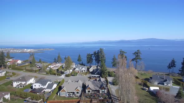 Aerial View of houses by the ocean. alt