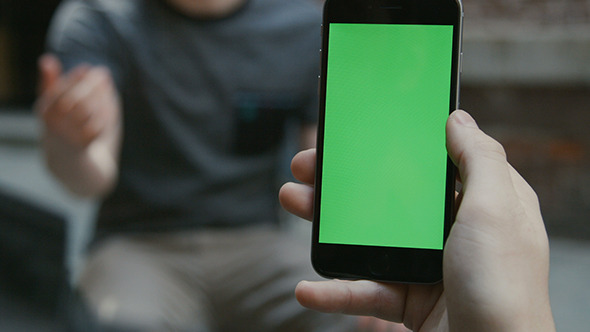 Guy Using Smartphone with Green Screen alt