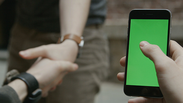 Guy Using Phone with Green Screen Handshake