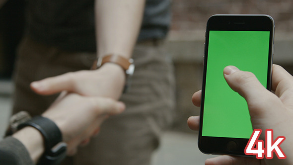 Guy Using Phone with Green Screen and Handshake