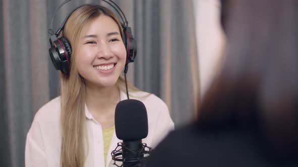 Young Asian women influencers' conversations while recording podcasts.