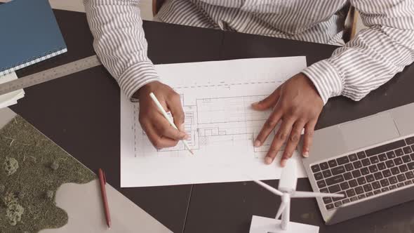 Engineer Drawing Blueprint at Office Desk alt