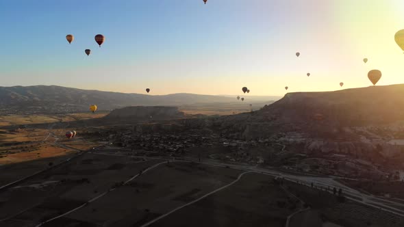 Aerial Hot Air Balloons Flying Over Hoodoos Fairy Chimneys in Cappadocia Turkey at Sunrise Morning alt