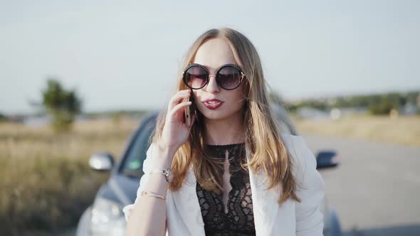 Beautiful Model Making Call for Car Repair Help Out of the City alt