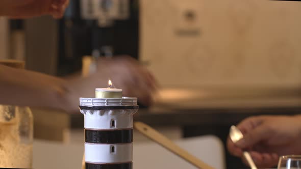 Close Up Putting Candle in Candlestick in Shape of Lighthouse, Romantic Dinner