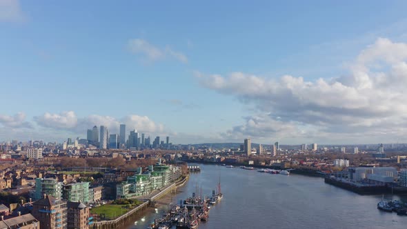 Aerial drone shot towards Canary Wharf skyscrapers from central London thames alt