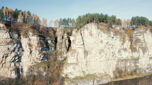 Aerial view; camera making panorama of landscape with cliffs forest