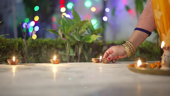 A Women Lighting a Lamp