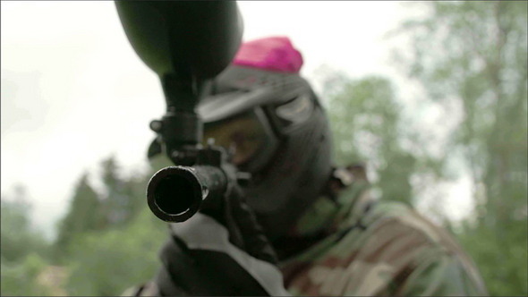 A Paintball Shooter Eyeing a Target alt