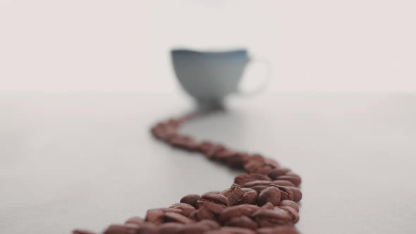 Coffee beans and cup in the making of a cup of coffee 2 alt