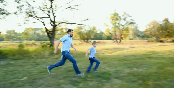 Father and Son Playing Outside in Summer