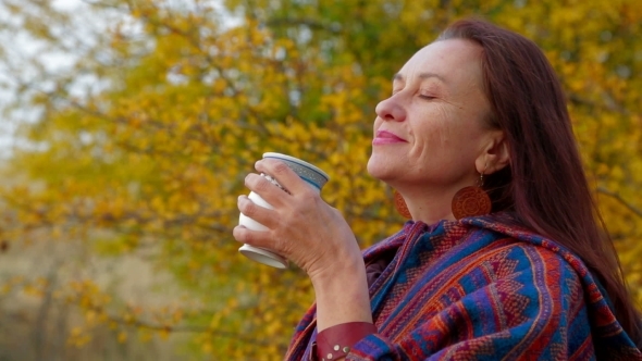 Woman Of Middle Age With Mug Of Cocoa In Autumn