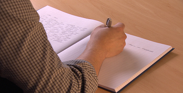 Man Writes Several Lines in Notebook