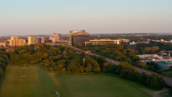 rising drone shot of corporate buildings surrounding motorway Brentford London alt