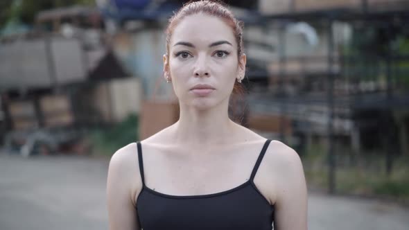 Portrait of Beautiful Serious Caucasian Redhead Woman Posing Outdoors alt