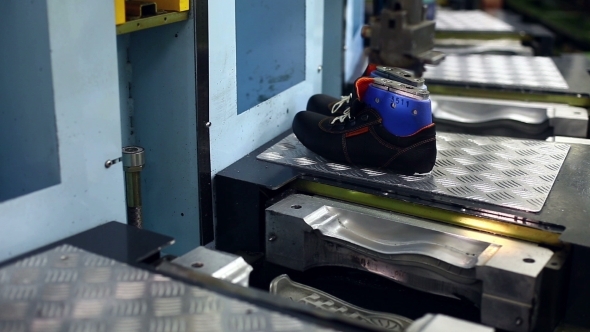 Working Woman Processing Boots On Machine  alt