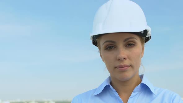 Serious Female Engineer in Helmet Looking Into Camera, Profession and Experience