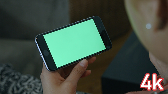 Girl Holding Phone with Green Screen alt