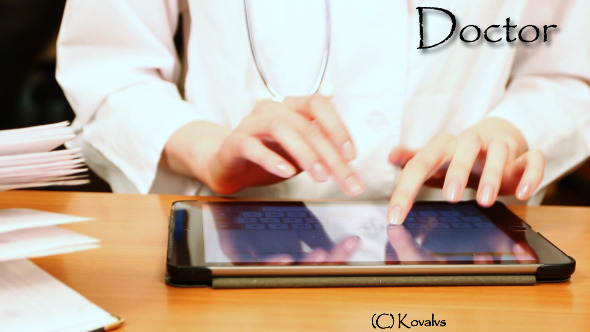 Doctor Working On Tablet Computer 