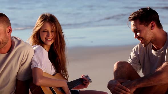 Smiling Friends Sitting On The Beach, Stock Footage | VideoHive