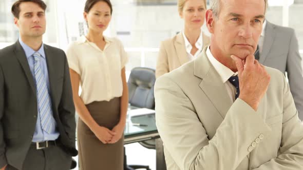 Businessman Thinking In Front Of His Staff alt