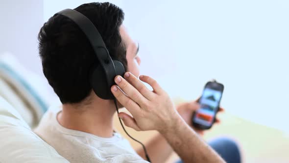 Cheerful Man Listening To Music With His Phone alt