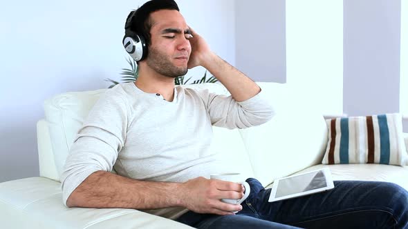Man Listening To Music With His Tablet Computer alt