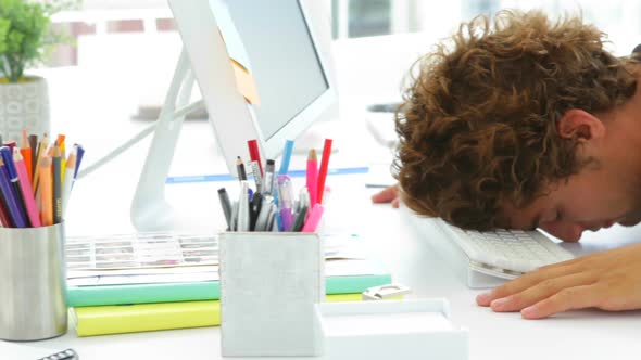 Exhausted Businessman Sleeping With His Head On The Keyboard alt