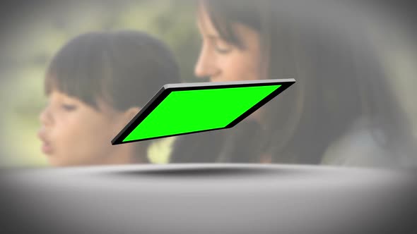Tablet With Green Screen In Front Of Family Outdoors alt