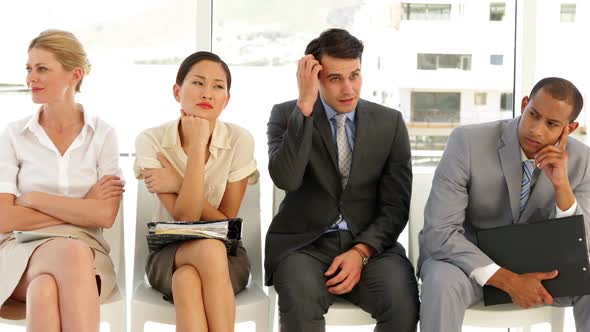 Business People Waiting For An Interview In A Row alt
