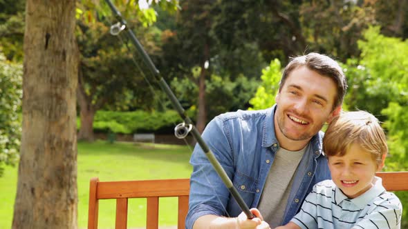 Father Teaching His Son How To Fish alt