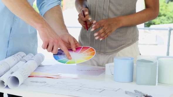 Mid Section Of Female Designer Advising Young Man alt