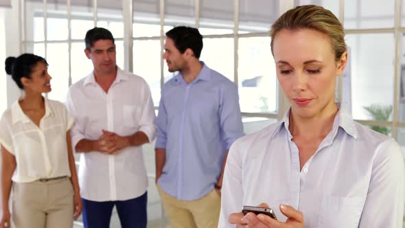 Female Creative Designer Text Messaging With Her Phone alt