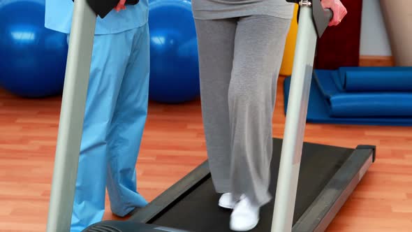 Physical Therapist Showing Patient How To Use Treadmill alt