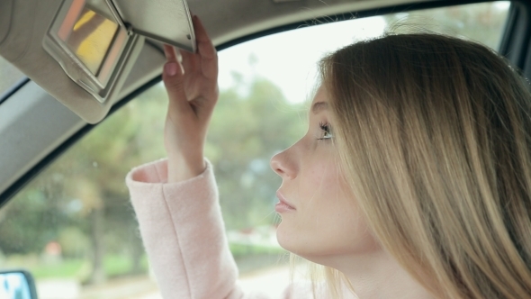 Sensual Woman Looking In Rear View Mirror