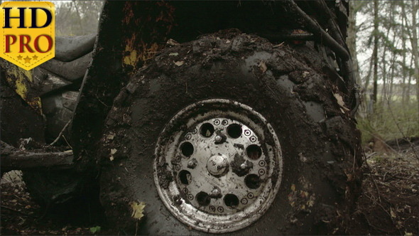 The Muddy Left Wheel of the Offroad Vehicle alt