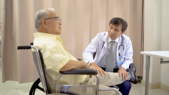 Orthopedist examines the knee of elderly patient to collect information for physical therapy treated alt