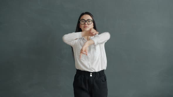 Slow Motion Portrait of Goodlooking Asian Lady Wearing Glasses and Formalwear Dancing Alone alt