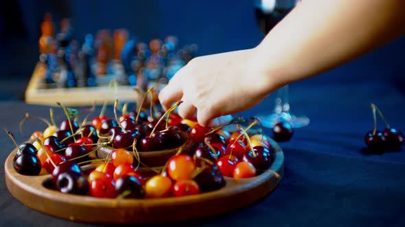 Close Up of Compartmental Dish with Different Varieties of Sweet Cherries on Table alt