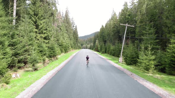 Athlete cycling training and strength workout on bicycle. Cyclist cycling on bike alt