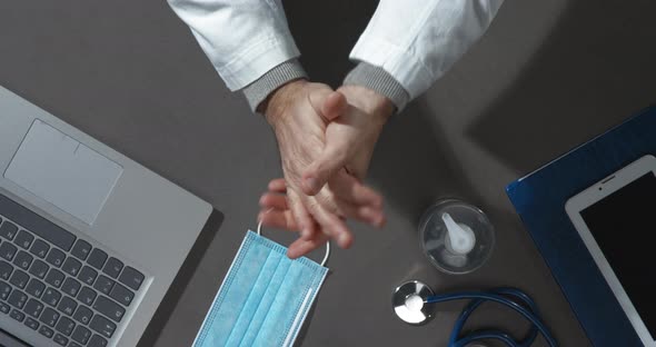 Doctor applying sanitizer on his hands