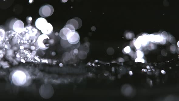 Super Slow-motion Shot of Pouring Water Against Black. alt