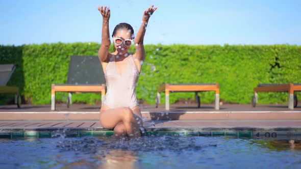 Young asian woman enjoy around outdoor swimming pool for leisure alt